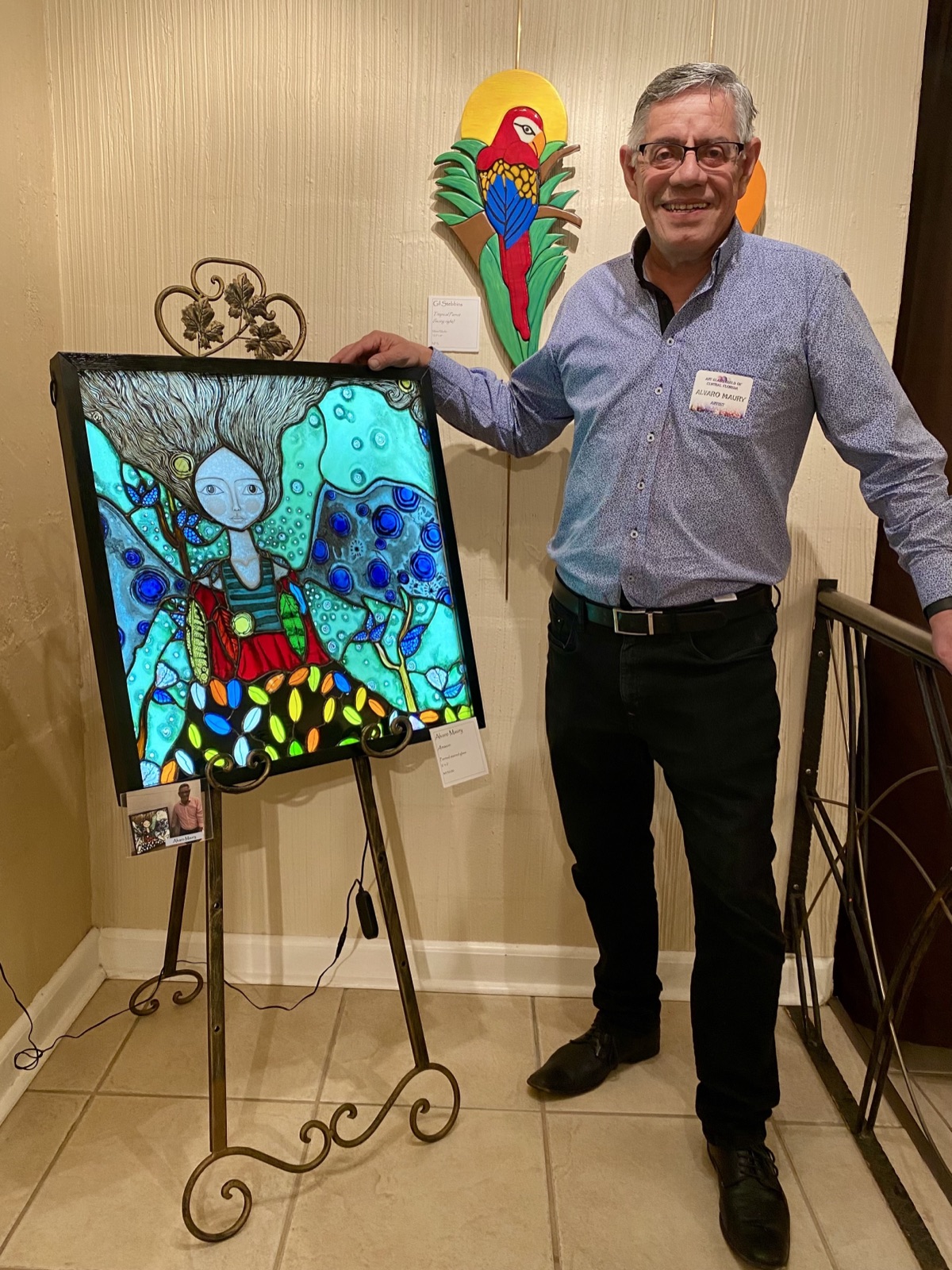 Alvaro Maury with one of his stained glass paintings