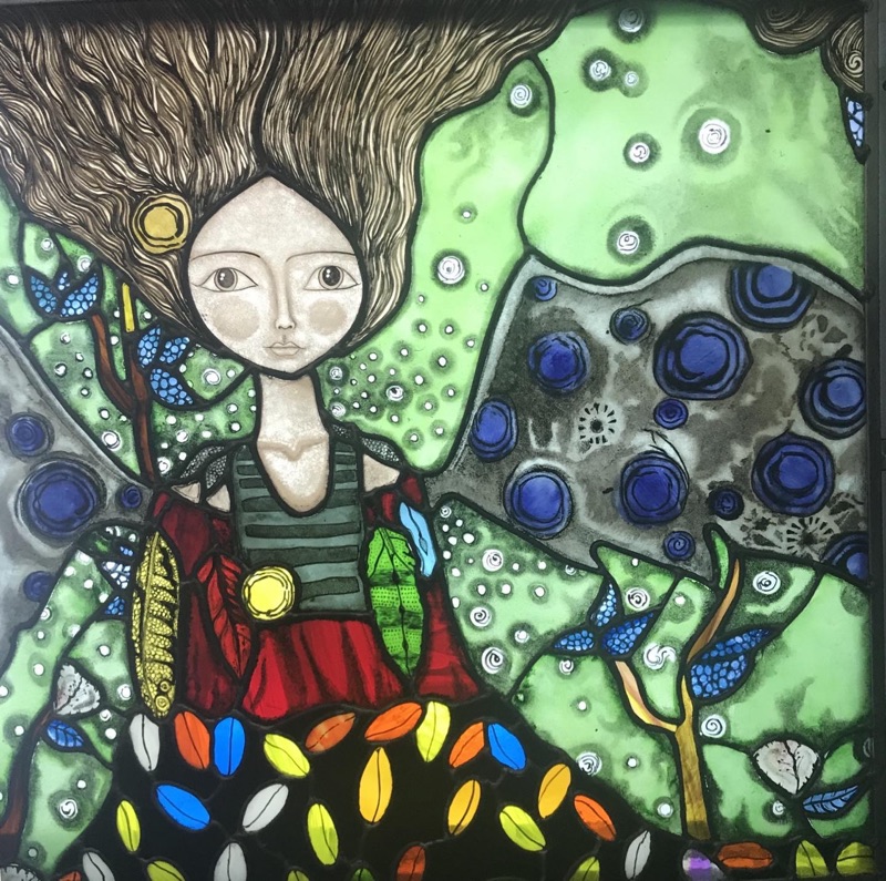 Stained glass painting of a girl in a colorful dress with flowing hair